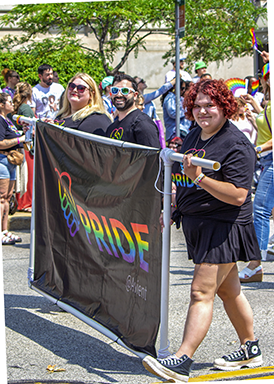 Group of Avient employees holding Pride flag at parade