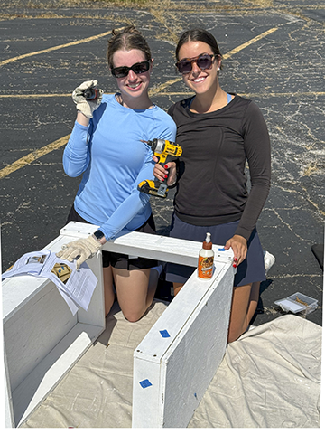 Employees building mailbox for books