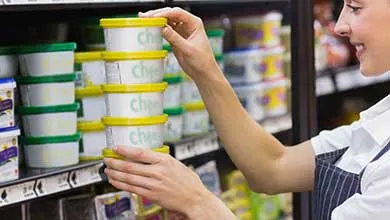 Female grocery worker holding containers