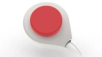 A white, teardrop-shaped device with a large red button on top and a clear pointed tip.
