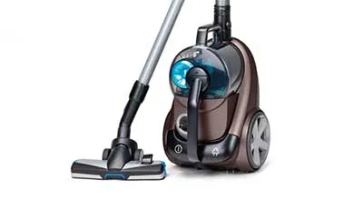 A brown and black canister vacuum with a silver wand and cleaning head on a white background.